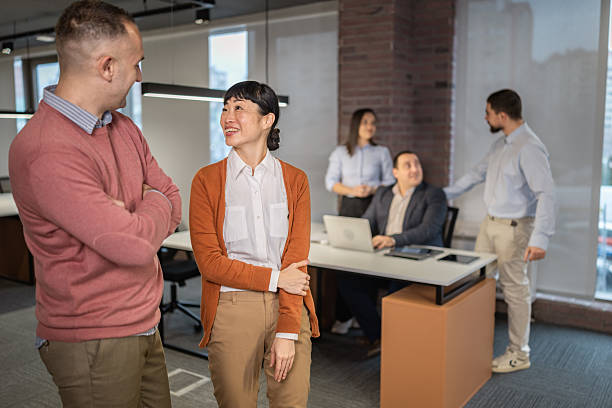 istock Diverse colleagues talking and smiling in the modern office 2254385307