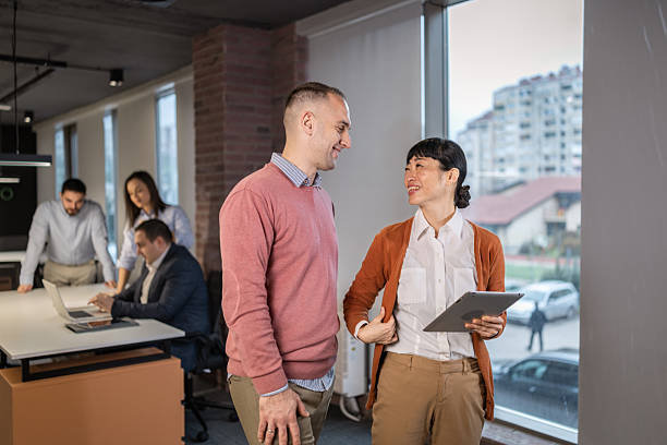 istock Diverse business colleagues discussing data and business strategy on a digital tablet 2254386436