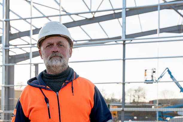 istock Construction worker stands proudly at metal framework site under clear blue sky 2254387073