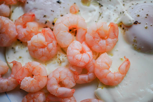Freshly cooked shrimp ready for a seafood feast. A vibrant display of freshly cooked shrimp, showcasing their pink hues and juicy texture