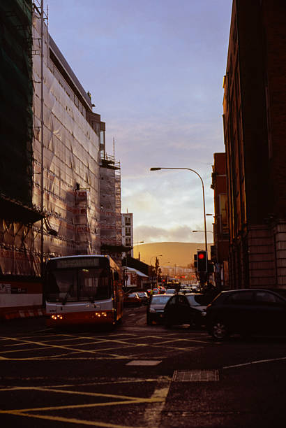 Cork, Ireland - Oct 12, 2024: Late afternoon warm sunlight shines on the St. Patrick's Bridge and the bridge street.