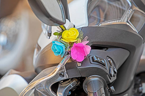 small flower bouquet attached to a motorcycle handlebar.