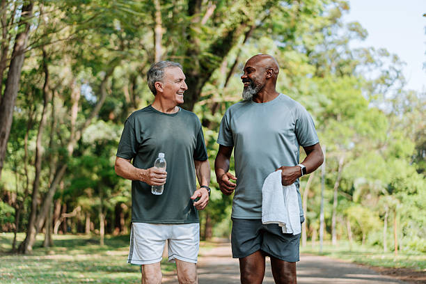 istock Elderly friends walking in a public park 2254392088