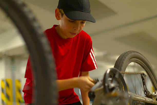 istock Adolescent in bright clothing prepares bicycle for city commute efficiently 2254392545