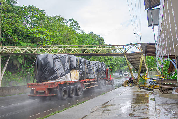 A truck carrying cargo drives through the lush landscapes of San Cipriano, Buenaventura, Valle del Cauca, Colombia.