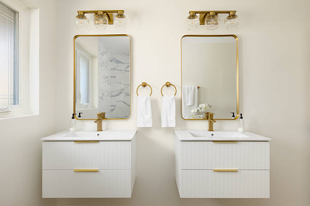 istock A bathroom with floating white cabinets and gold fixtures. 2254395227
