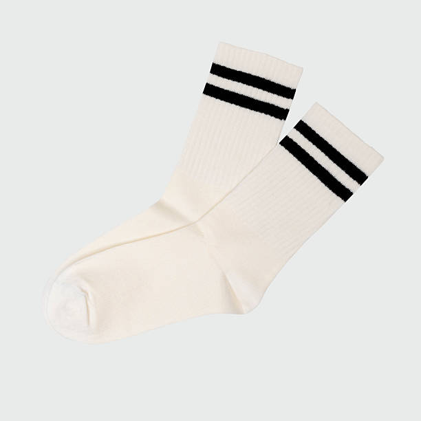 istock Pair of white athletic socks with black stripes on neutral background 2254397469