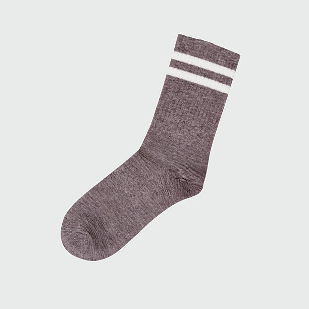 istock Gray woolen sock with white stripes on light background 2254397819