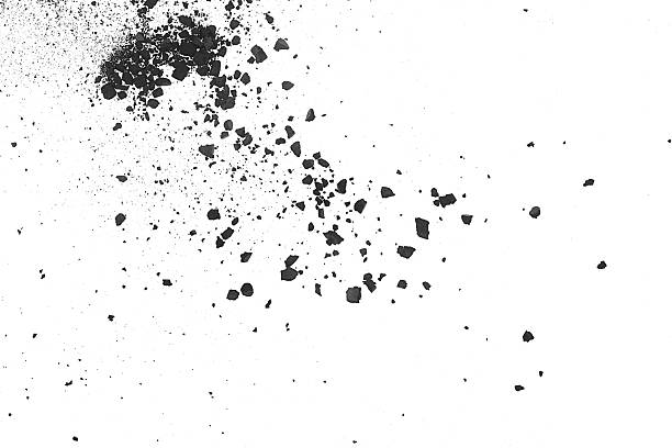 istock Small charcoal pieces with ash and dust splashing on a white background, top view. Black chalk pieces. 2254398509