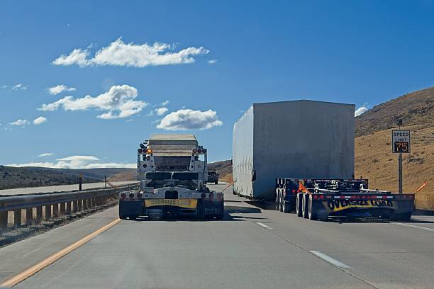 Oversize load passing an oversized load, the danger on American highways. Two wide loads speeding down the US Interstate highway with a 75 mph limit.