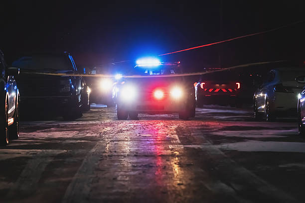 Group of professional cyclists training on highway with safety escort car, security light