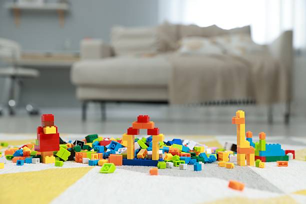Construction toy. Figures made with building bricks and colorful blocks on floor indoors