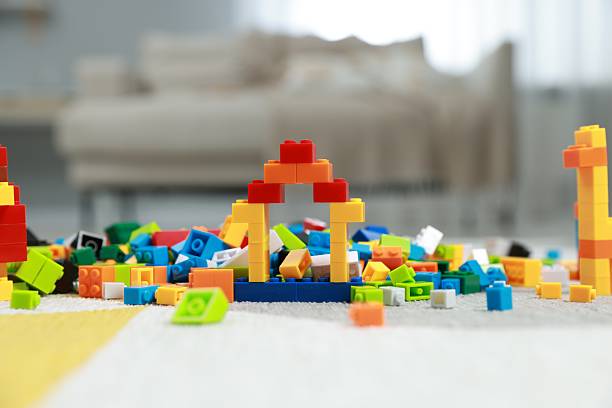 Construction toy. Figures made with building bricks and colorful blocks on floor indoors
