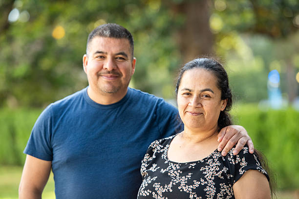 istock Smiling hispanic mature couple posing at a park looking at the camera 2254405721