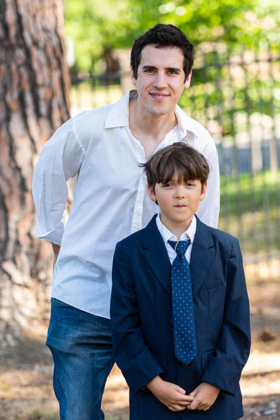 Smiling young father and son looking at the camera