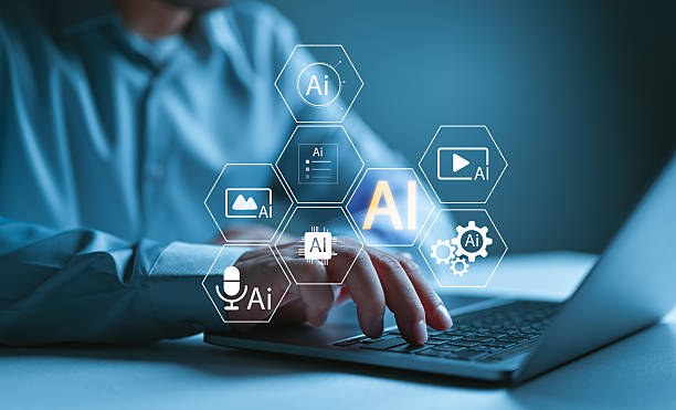 istock AI integration in digital workflow concept. Man working on laptop with futuristic interface showing artificial intelligence icons for voice, text, image, video, automation, and smart processing tools. 2254409292