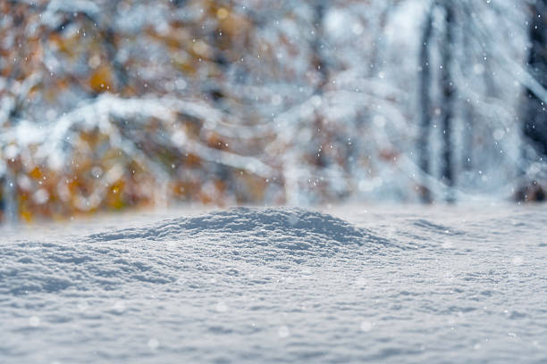 Beautifull background on a Christmas theme with snowdrifts, snowfall and a blurred background