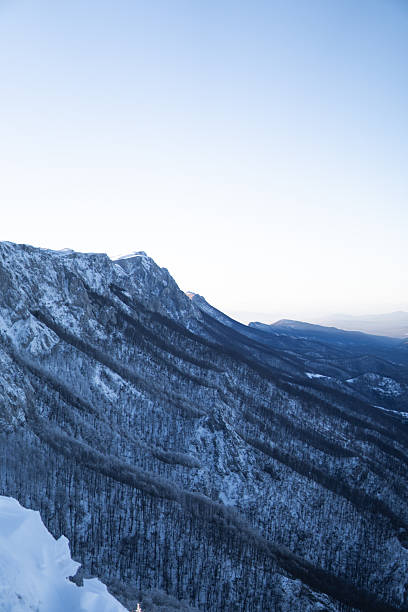 istock Mountain ridge covered with snow with mountain range in the back 2254409786