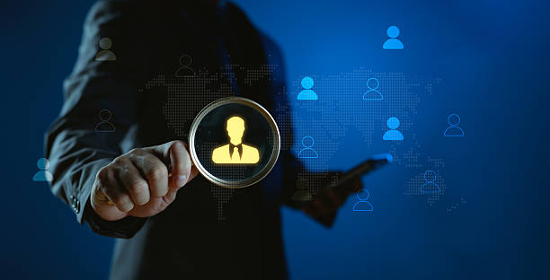istock HR technology concept with magnifying glass focusing on candidate icon over digital world map. Represents talent search, recruitment, CMS, HRM, and modern human resource management systems. 2254409806