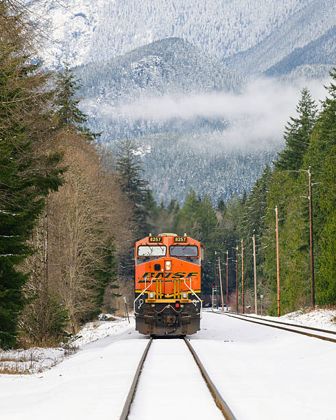 Baring, WA, USA - December 28, 2025; BNSF freight locomotive approaching in winter snow scene in Cascade Mountains