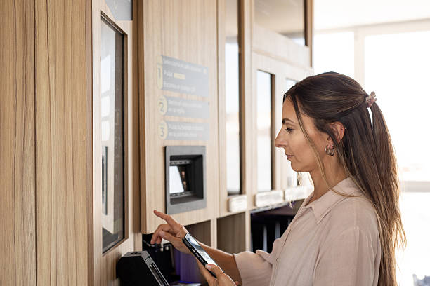 istock Young woman paying at a smart coffee vending machine 2254411338