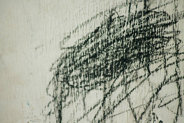 Dark surface features swirling patterns and textures resembling natural forms.