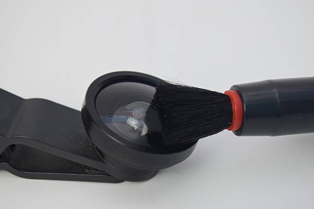 istock Professional cleaning of a mobile phone camera lens using a specialized black soft brush 2254416426