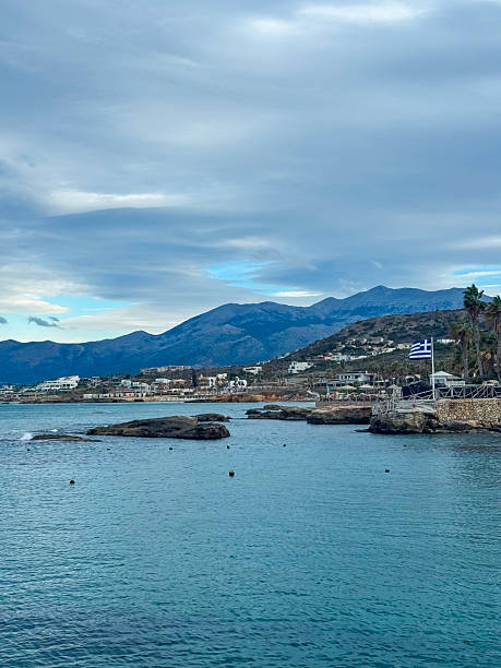 istock Scenic coastal view showcasing a tranquil shoreline and mountainous backdrop under a cloudy sky during a calm afternoon in Greece 2254417857
