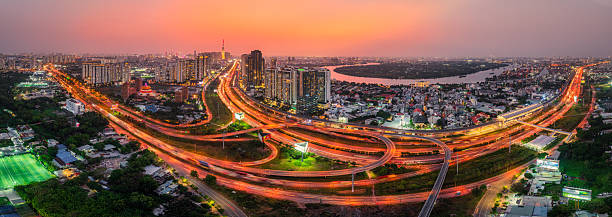 Drone view of District 2 with crisscrossing roads and flyovers in Ho Chi Minh city in sunset, South Vietnam