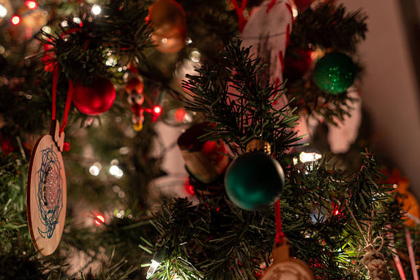 istock Ornaments sparkle. Festive tree branches glow with holiday lights. 2254421152