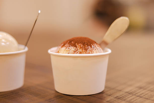 One cup of tiramisu ice cream serving in cup with spoon.