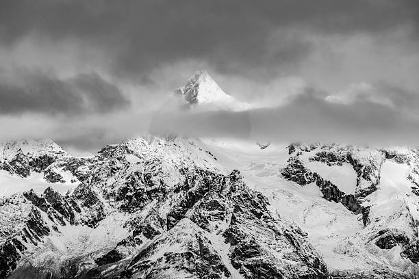 Ober Gabelhorn Emerges From Thick Clouds In The Swiss Alps in early winter