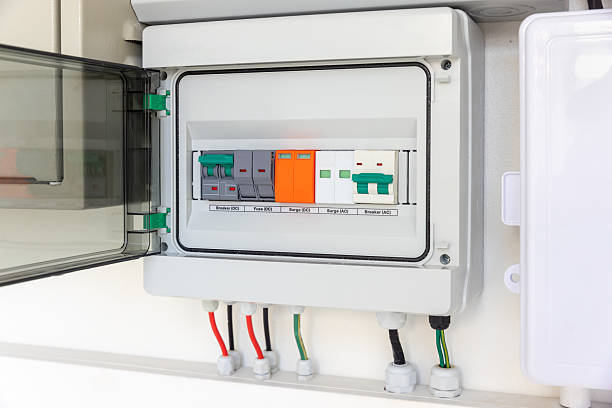 istock Solar Combiner Box on a House Wall with Integrated DC and AC Safety Components (Breakers, Fuses, Surge Protection) for a Hybrid PV System. 2254428165