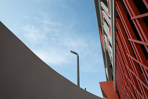 The red neon sign for the HOTEL on the roof of the building. Green roof windows and satellite dishes. Tourism, Architecture. Selective focus.