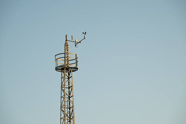 A tall tower with communications equipment and the sky as a background.
