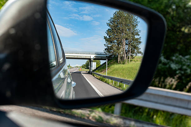 istock Car rearview mirror showing nature 2254432031