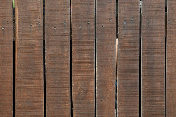 Top view of dark brown rustic wooden plank texture.