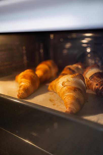 istock Croissants Baking in Professional Bakery Oven 2254433551