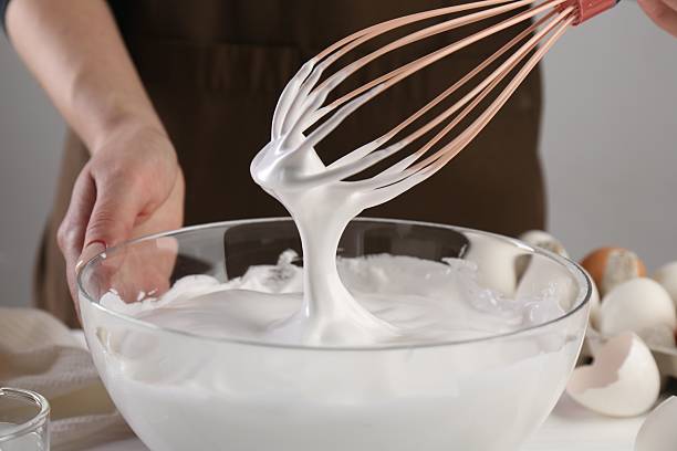 istock Woman making whipped cream with whisk at table, closeup 2254435336