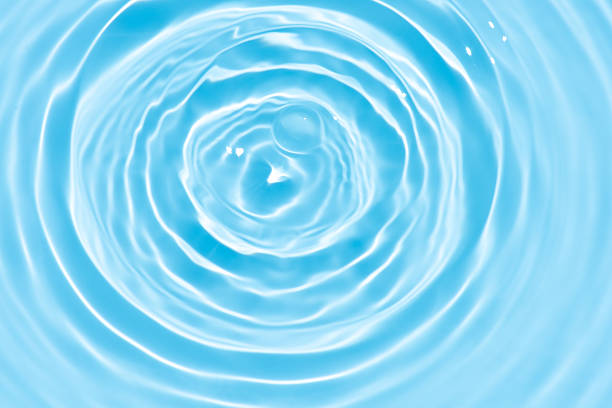 istock Bluewater waves on the surface ripples blurred. Defocus blurred transparent blue colored clear calm water surface texture with splash and bubbles. Water waves with shining pattern texture background. 2254435391