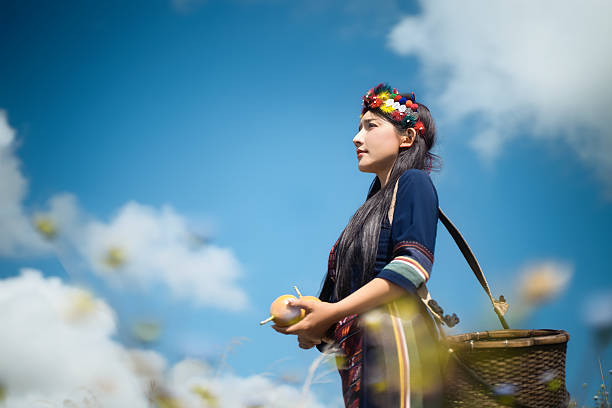 A rural woman picking fruits under the blue sky