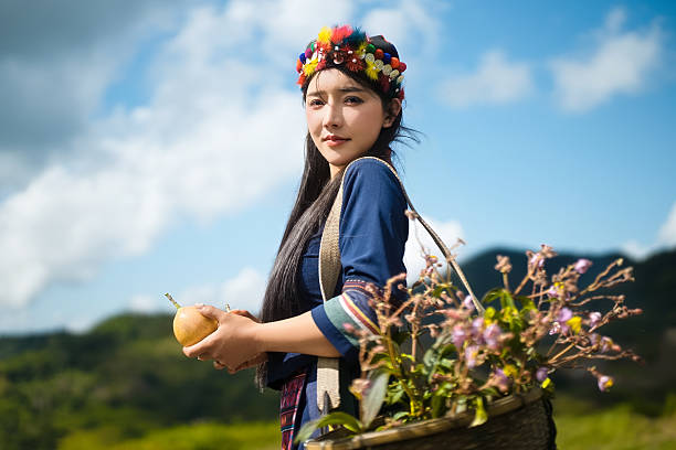 A rural woman picking fruits under the blue sky