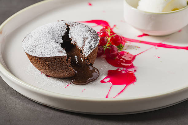 Warm chocolate lava cake with flowing center and powdered sugar