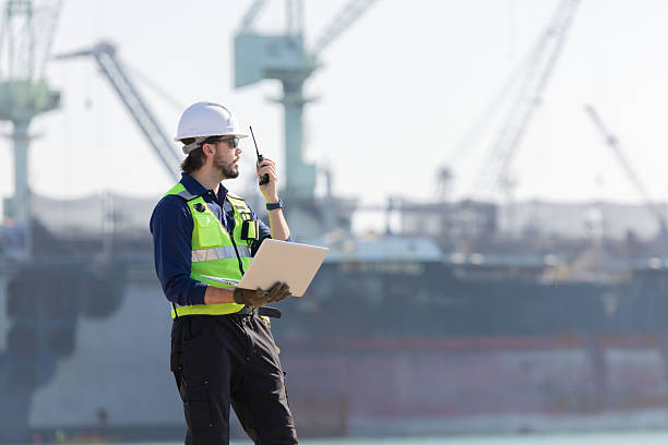 istock Worker work at a port with a cargo ship in the background 2254438885
