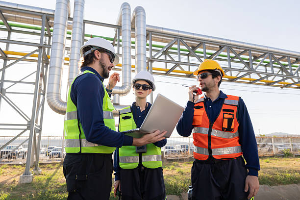 istock Petroleum engineers with hardhat working at oil refinery site 2254438924
