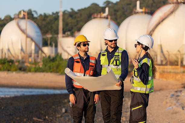 istock Petroleum engineers having a discussion near oil storage tanks 2254438974