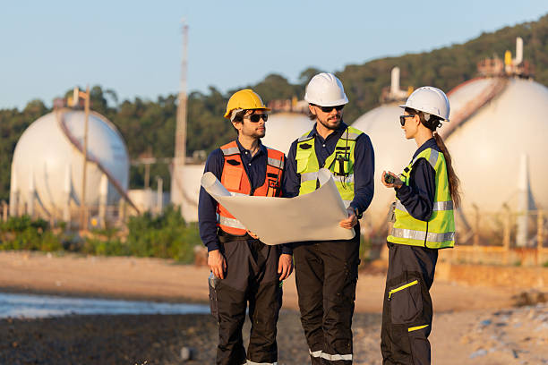 istock Petroleum engineers having a discussion near oil storage tanks 2254438975