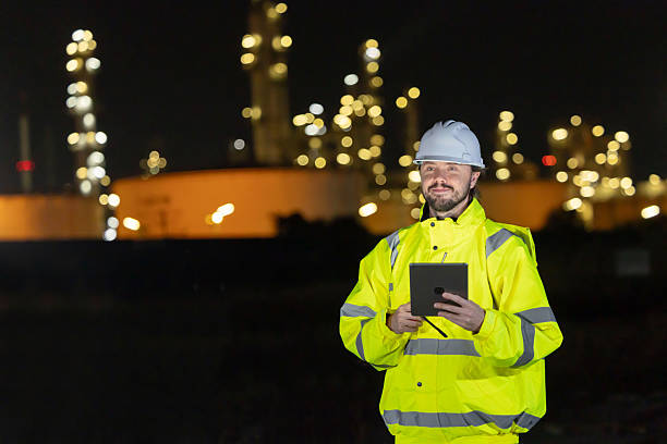 istock Petroleum engineers working at oil refinery site at night 2254439054