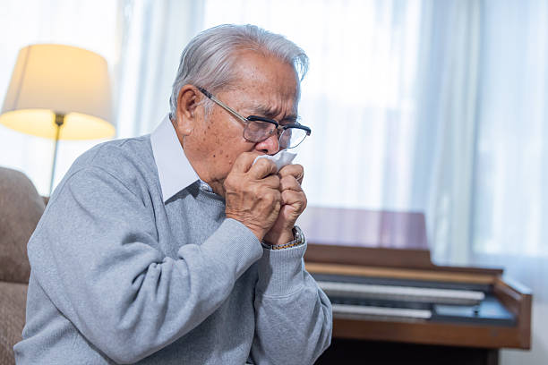 istock Elderly man sneezing suffer from catching cold 2254441942
