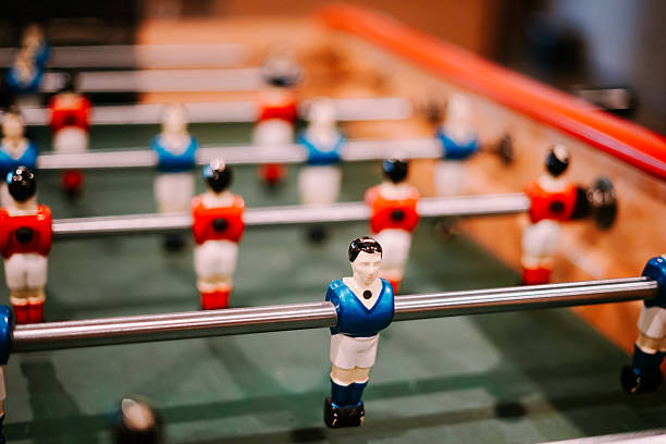 istock Classic Table Football Game with Blue Player Figure Close-up 2254442057